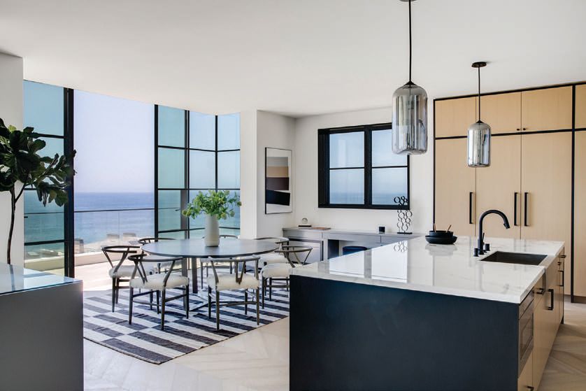 The airy kitchen features floating pendants by Troy Lighting District. PHOTO BY CHAD MELLON