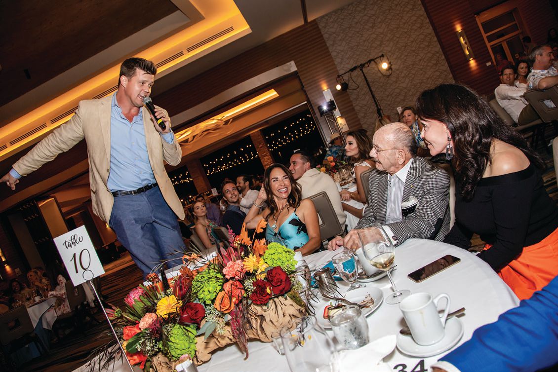A candid moment with auctioneer Zach Krone at Childhelp’s Beach Ball PHOTO BY CARL CARPENTER