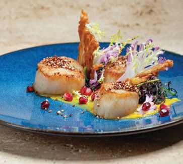 Order the seared scallops and pull up a seat in the waterfront dining room at Splashes at Surf & Sand Resort PHOTO COURTESY OF BRANDS