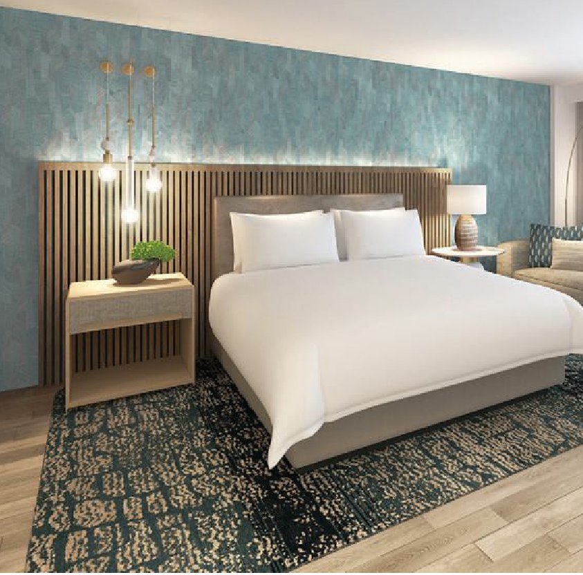 Guest rooms channel the beach with tans and blues. PHOTO COURTESY OF VEA NEWPORT BEACH