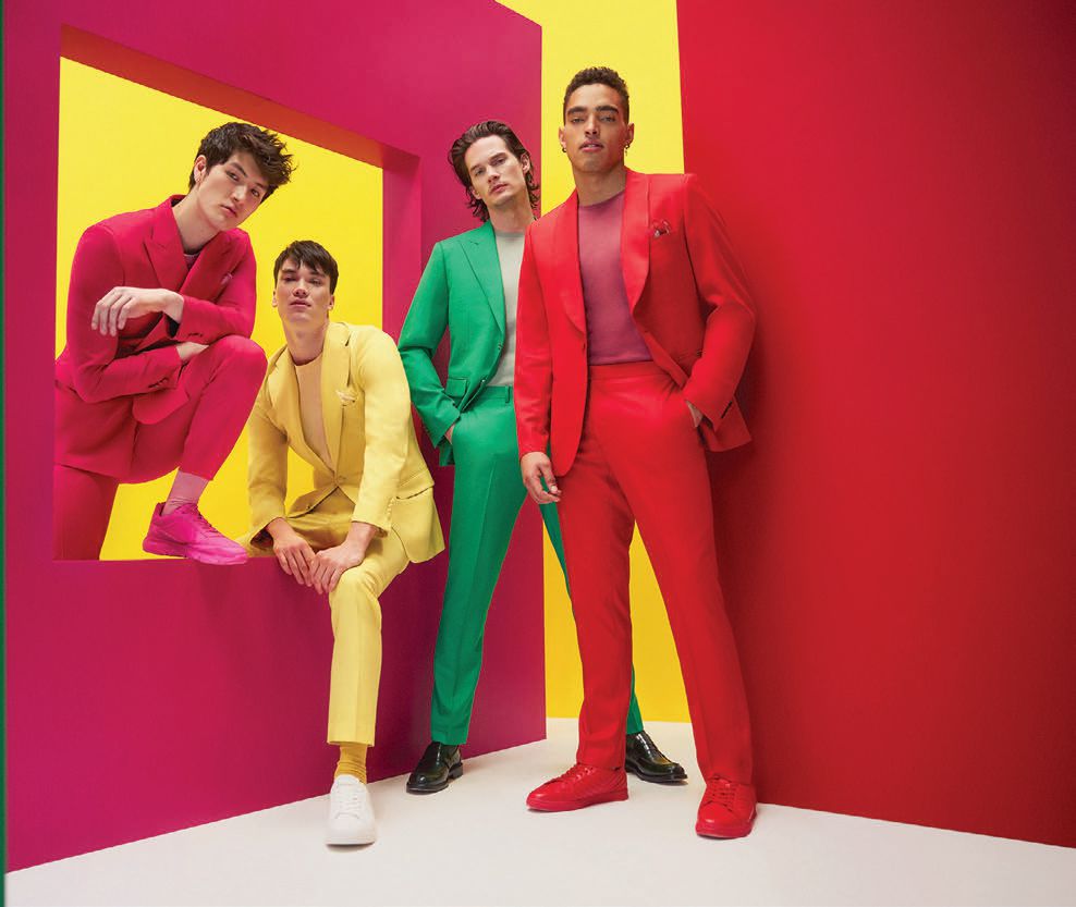 Spring and summer suits get a bold kick of color thanks to Indochino. Here, models don Harrogate suits in fuchsia, yellow, green and red. PHOTO COURTESY OF BRANDS