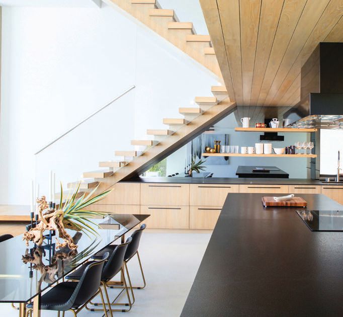 Summer Jensen tried to maximize the kitchen cabinetry storage under the floating staircase PHOTO BY TOSTI STUDIOS