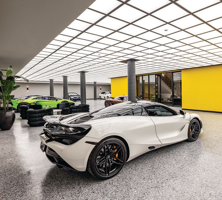 Museum-style lighting illuminates the 30-car garage, which includes a Tesla Powerwall and epoxy floors PHOTO BY DAVID HEATH OF WESTERN EXPOSURE