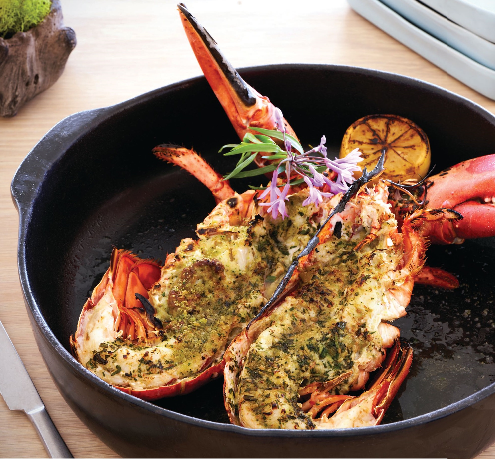 The 1 ½-pound broiled whole spiny lobster is topped with garlic tarragon butter and breadcrumbs. PHOTO BY KEVIN MARPLE