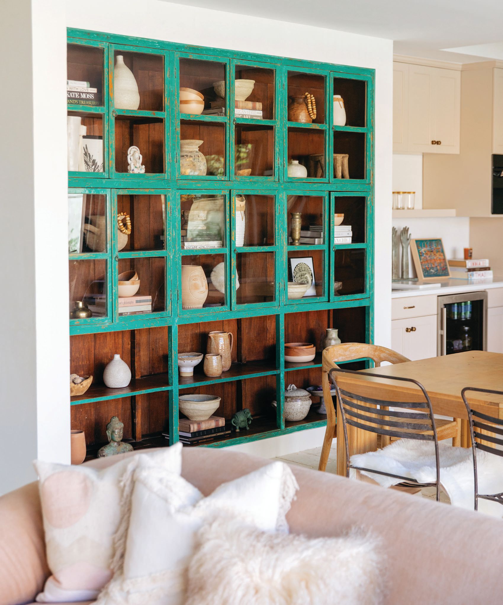 A large turquoise cabinet from Bali is built into one of the kitchen walls. PHOTO COURTESY OF ANGELA O’BRIEN