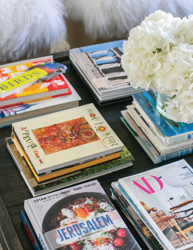 The coffee table displays art, travel and cooking books. PHOTOGRAPHED BY RYAN GARVIN