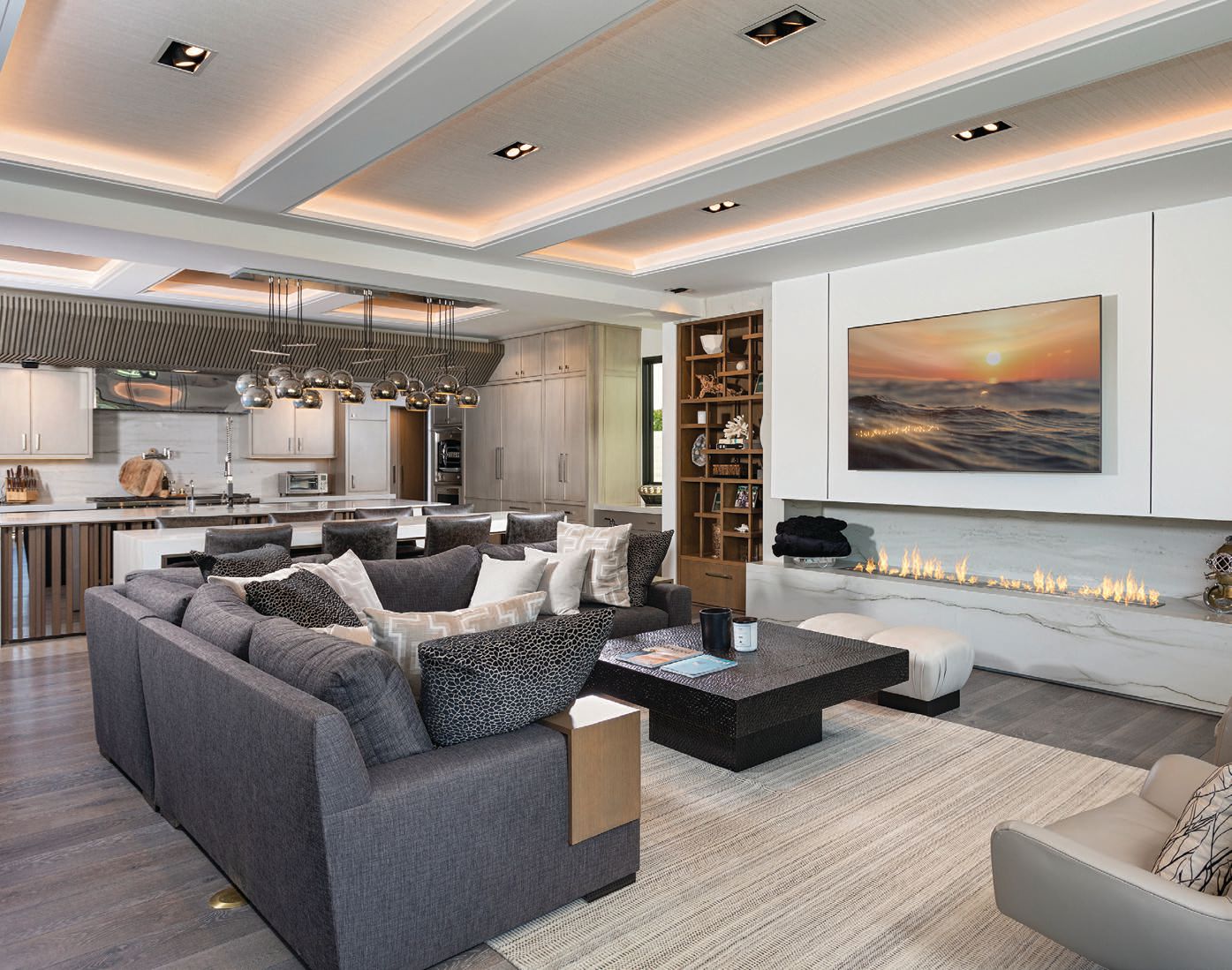The sleek living room is connected to the gourmet chef’s kitchen. PHOTO BY ADAM DUBICH