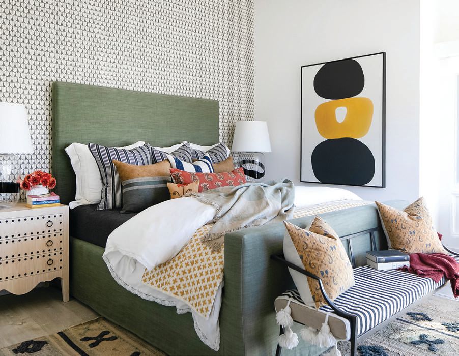 The color palette and art in the main bedroom evoke Spain. PHOTOGRAPHED BY RYAN GARVIN